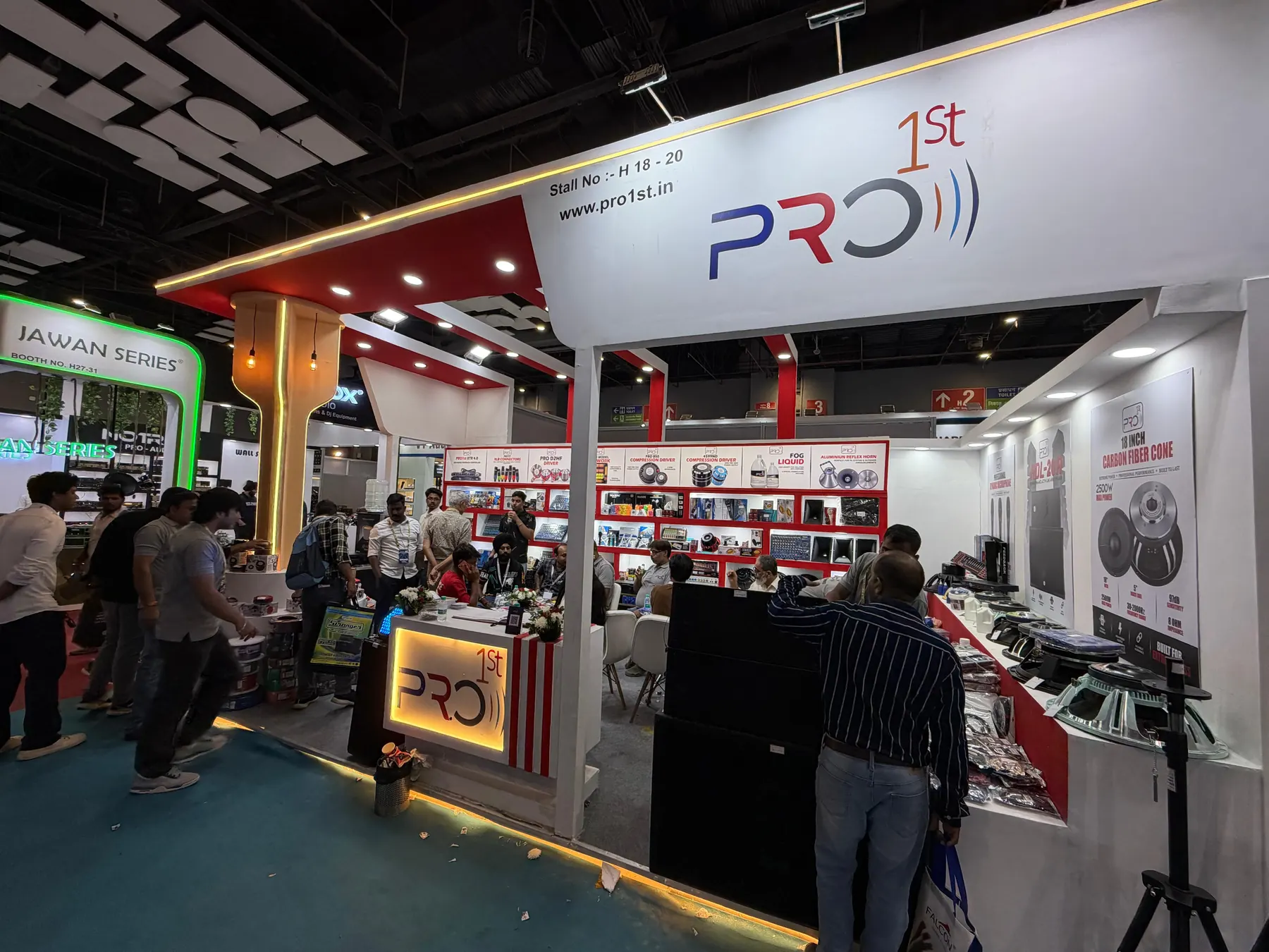 The PRO1ST stand at a trade show, the range on the shelves behind a lit counter
